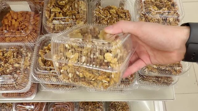 Choosing a variety of nuts at the supermarket