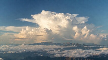 Fototapeta premium Massive cloud looms above distant mountain peaks