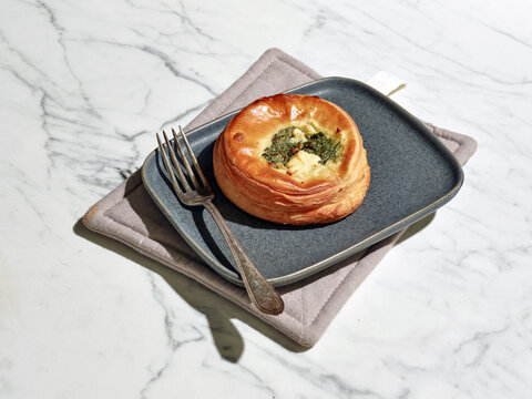 Savory spinach and goat cheese pastry on plate with hard light