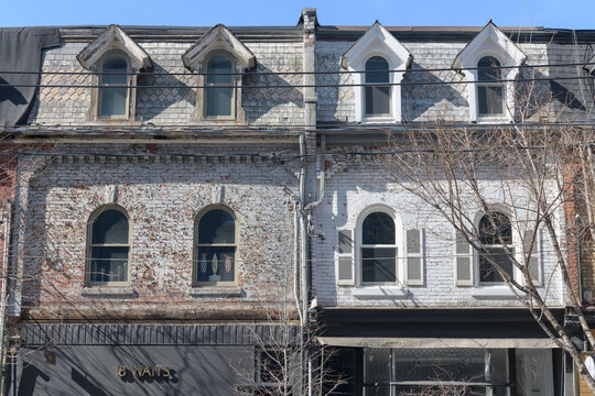 exterior building facade and signs of 18 Waits and ZEI Pottery Studio, 990-988 Queen St W, Toronto