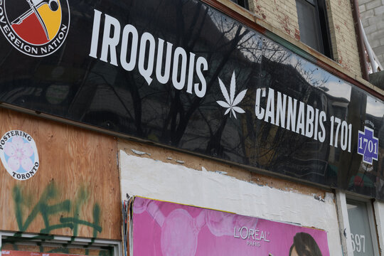 ghost sign of Iroquois Cannabis 1701 located at 697 Queen St W, Toronto