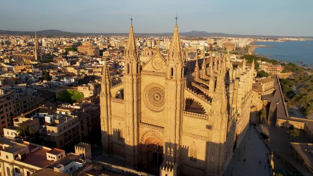 Palma de Mallorca Cathedral Aerial Drone Pull-back at Sunset, La Seu Gothic Basilica Close-up to City Skyline and Waterfront Panorama View, Balearic Islands Spain Luxury Travel Destination 4K Video