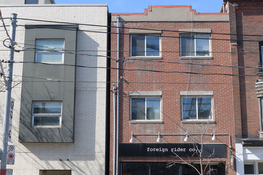 exterior building and sign of Foreign Rider Co, a clothing store, located at 964 Queen St W, Toronto