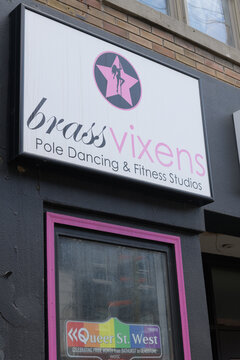 exterior sign of Brass Vixens, a physical fitness program, located at 721 Queen St W, Toronto
