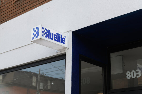 wall mounted projecting sign outside Blue Tile Lounge, a skateboard shop, located at 803 Queen St W, Toronto