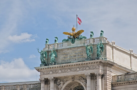 Detail of the Hofburg palace, with statues of angels and golden imperial two headed eagle and royal crown 