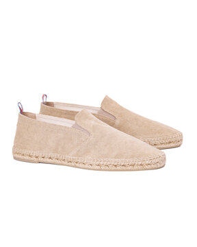 Pair of beige canvas espadrille shoes on white background