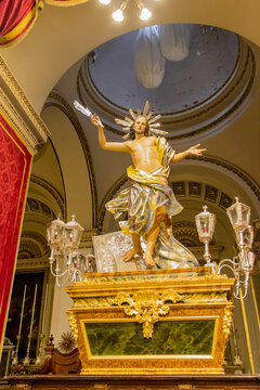 Ornate Resurrected Christ Statue On Baroque Processional Platform Inside Historic Catholic Church