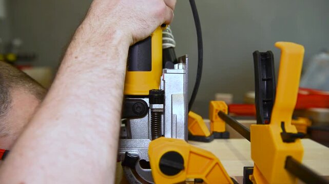 Wood lamella router in action cutting into a wooden surface. The spinning bit carves a precise groove as the attachment cutting into the material.