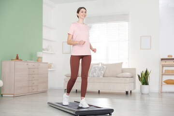Sporty woman training on treadmill at home, low angle view © New Africa