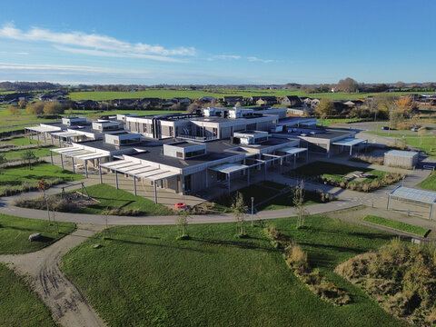 Modern school complex in Southern Denmark featuring contemporary architecture, open outdoor areas and interconnected learning buildings. The layout highlights green surroundings