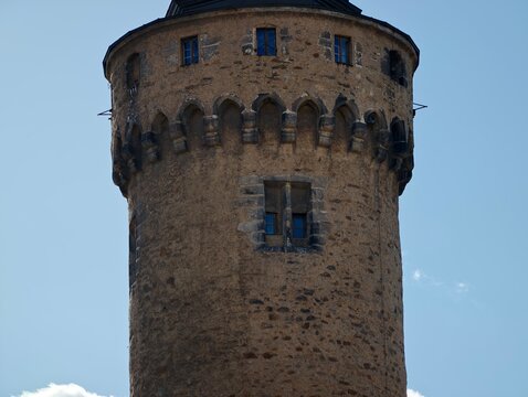 Detailed view of ancient cylindrical stone tower showcasing battlements and weathered masonry surfaces