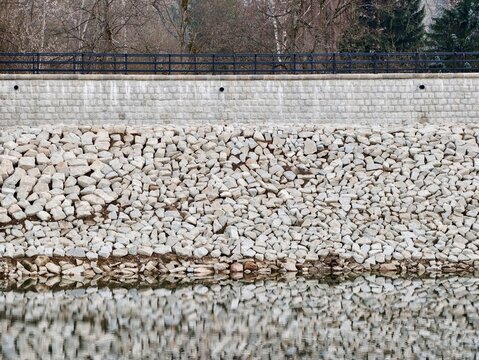 Stone pattern visuals. Minimalist depiction of riprap with tranquil water and erosion features