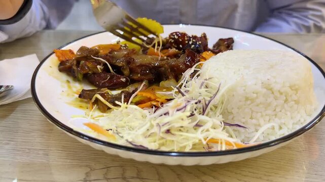 Trying local Asian street food.Tourist man eating asian food street local cafe