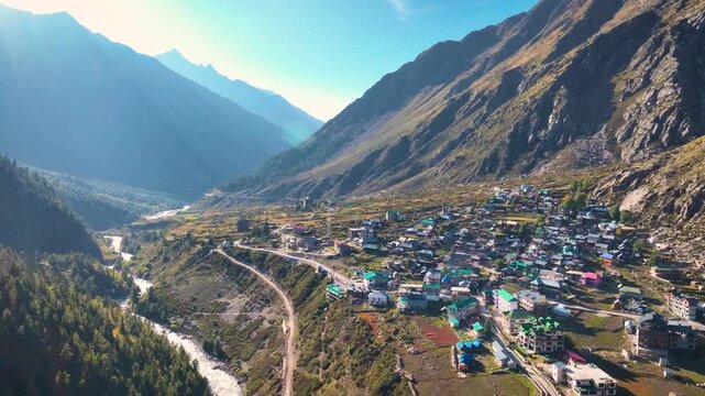 Epic aerial view of Rakcham village in the Baspa Valley with majestic snow-capped Himalayan peaks in the background.