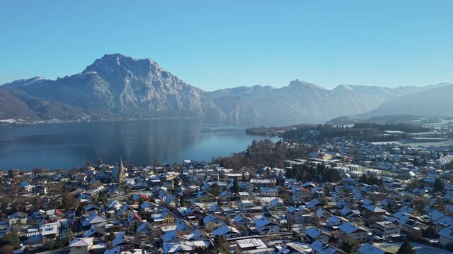 Aerial view of snowy Altm&uuml;nster village, Traunsee lake and Alps in winter, Austria