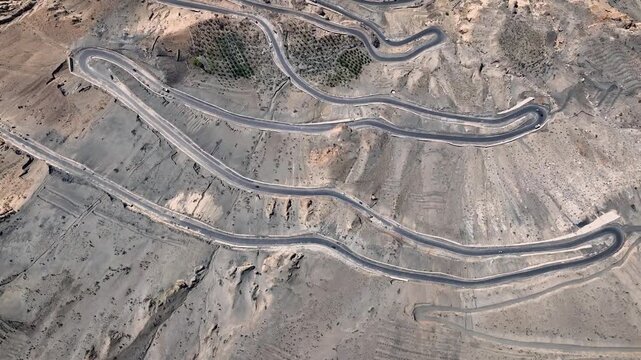 Top-down aerial of the zigzagging Ka Loops mountain pass and highway in Himachal Pradesh, India.