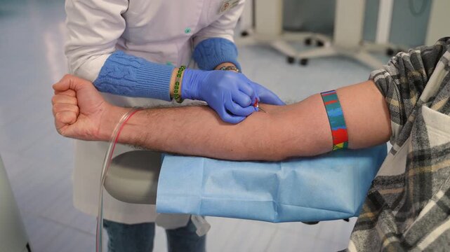 Nurse collecting blood from a patient during donation process