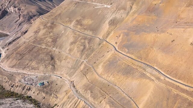 Aerial view of the steep, zigzagging mountain road from Kaza to Langza in Spiti Valley.