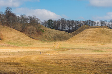 Obraz premium Between the hillforts and the mounds of Kernave in early spring, Lithuania, the medieval capital of the Grand Duchy of Lithuania, UNESCO world heritage, a tourist attraction