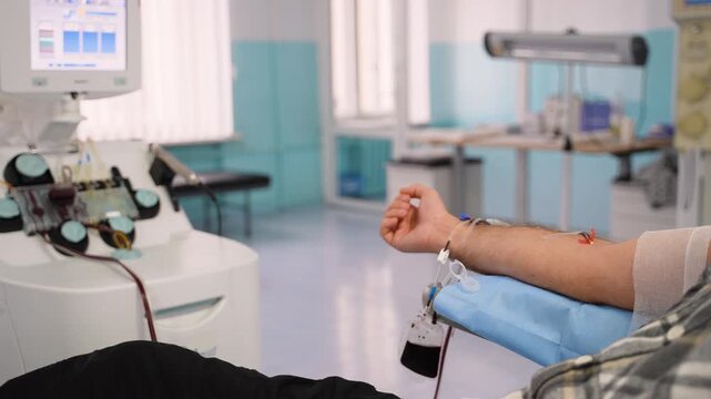 Male patient donating blood in hospital transfusion center