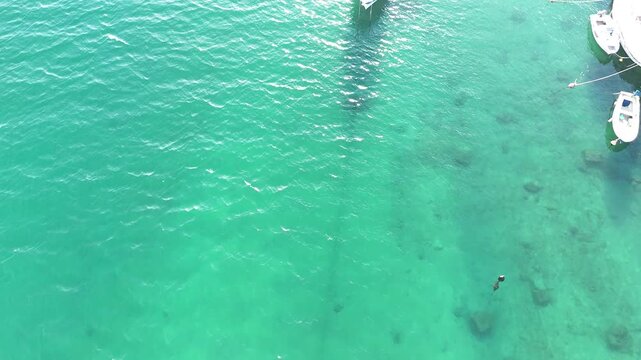 Aerial drone view of Omis, Croatia with Cetina river flowing through town, surrounded by mountains and scenic landscape, panoramic cinematic view of Dalmatian coastline and nature