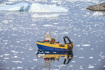 Ilulissat, Disko Bay, Greenland - Colorful Working or Fishing Boat Among Ice Floes in Arctic Waters Greenland © Sandra Falcetta