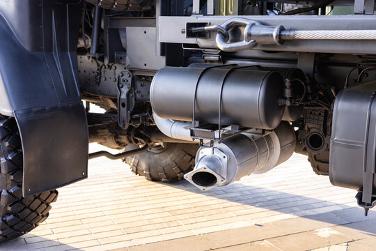 Military equipment and army equipment.. Professional checks rugged military truck for potential issues or deterioration. Skilled technician meticulously evaluates underbody of tough military
