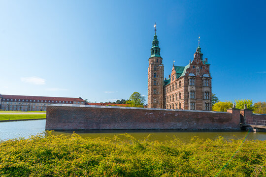 Copenhagen, Denmark - May 12 2017: Rosenborg Castle with moat and historic brick architecture on sunny spring day in Copenhagen.