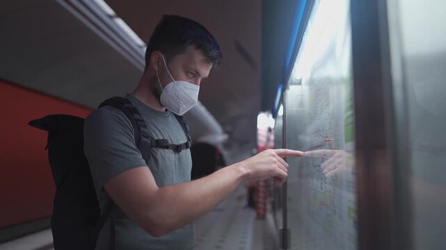 Sick man wearing a mask to protect others while commuting in Germany. Fahrgast mit Schutzmaske am Muenchener U-Bahnhof. Nahverkehr wegen eines Streiks ausfaellt. Train cancellations.