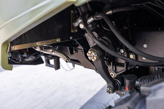 Military equipment and army equipment.. Indepth examination of chassis and engine attachment mechanisms. Comprehensive inspection of foundational vehicle support and engine mounting systems