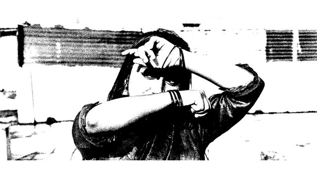A woman in a dark saree covering her face with her hands in a black and white photo