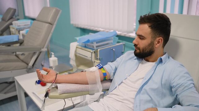 Young man donating rare blood in a hospital transfusion center