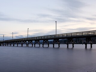 Fototapeta premium Long pier at sunset in Washington.