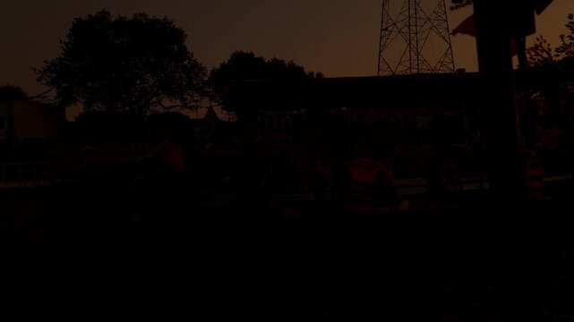 Beautiful sunset view at Guptar Ghat on the Sarayu River in Ayodhya, Uttar Pradesh. Calm flowing water, a long bridge silhouette, and warm golden sky, creating a peaceful spiritual atmosphere.