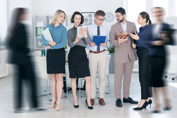 Fototapeta premium Busy coworkers in office, motion blur effect
