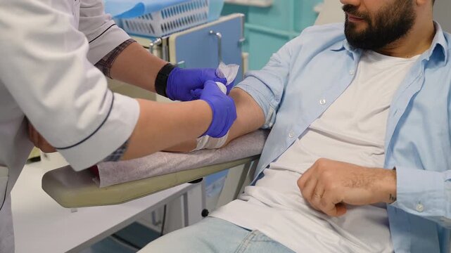 Nurse applying a bandage after blood donation