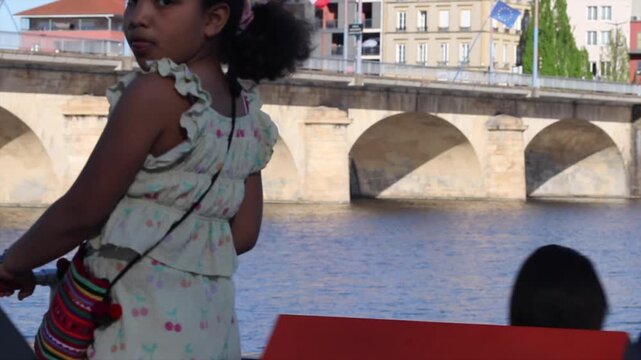 Young girl enjoying riding her scooter in roanne france