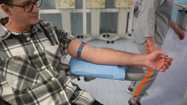 Nurse preparing male patient for blood donation