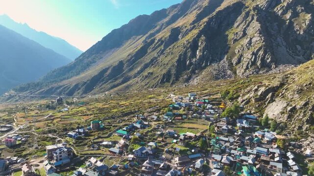 Epic aerial view of Rakcham village in the Baspa Valley with majestic snow-capped Himalayan peaks in the background.