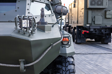 Military equipment and army equipment.. Detailed view emphasizing sturdy tires and reinforced bumpers. Close examination of combat vehicle featuring robust tires and strengthened bumpers © NastyaPhoto