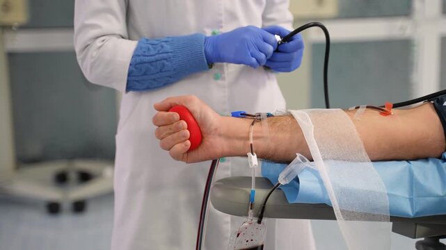 Volunteer man donating blood at hospital center