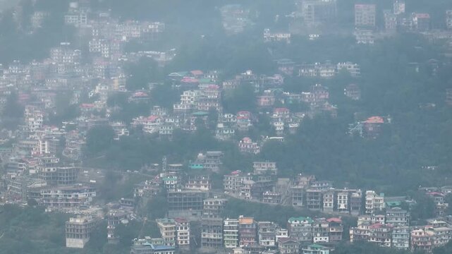 Cinematic camera tilt down revealing extreme urban sprawl and tightly packed houses on the Shimla hillside.