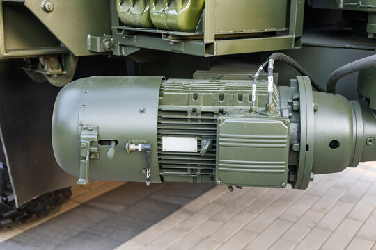 Military equipment and army equipment.. Military vehicle equipped with underbody winch and visible components. Army truck fitted with winch located beneath vehicle and its accompanying