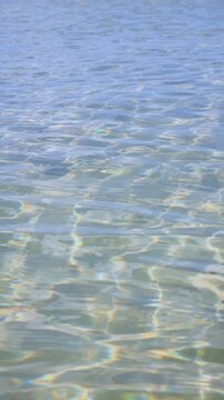 Abstract Crystal Clear Shallow Water with Iridescent Light Reflections and Sand Ripples. Tropical Beach