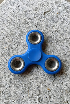 Spiner on the stone surface. Spinner on the stone table