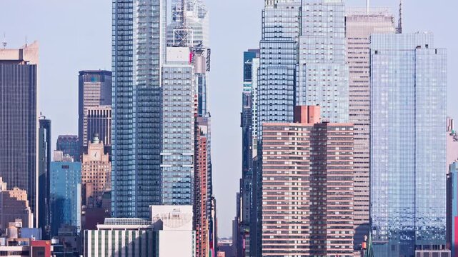 Revealing shot of New York City skyline along 42nd street canyon