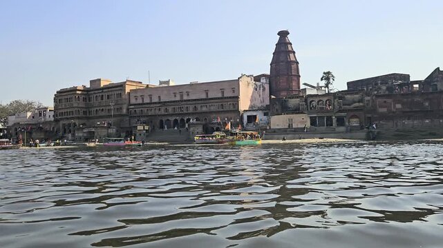 Scenic view of Kaliya Ghat (Kalideh) in Vrindavan from the Yamuna River, showcasing historic temples, ghats, and traditional architecture. This sacred location is associated with Lord Krishna