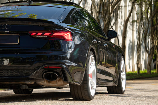 Black Audi RS5 low angle rear half view, Luxury Sports seda outdoors on city street