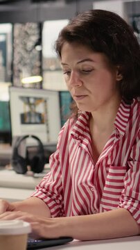Vertical Video Female worker, woman at desk with laptop, working in smart office corporation, providing business administration for new strategy and project growth. Staff ensuring productivity startup